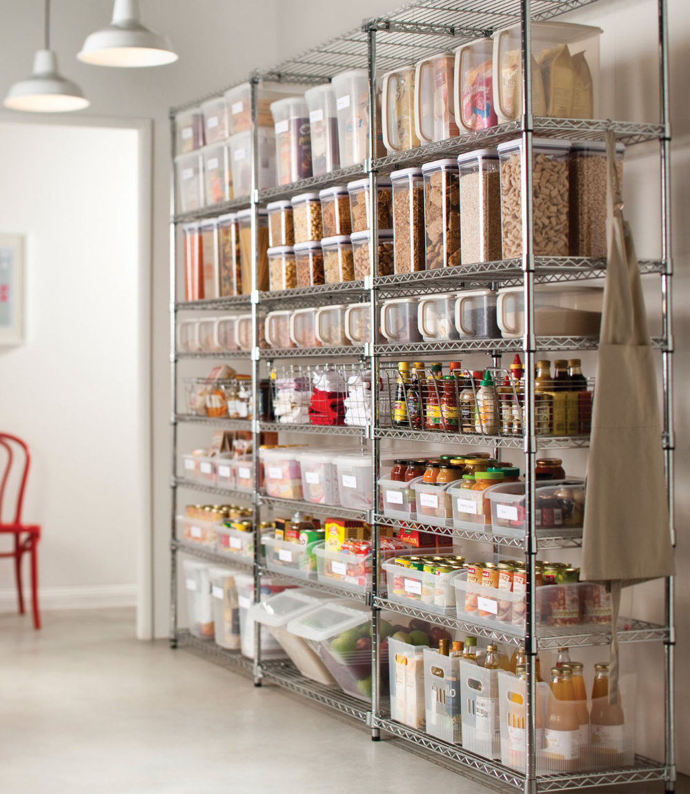 Commercial-style pantry with metal shelving and airtight containers for dry goods, sauces, and oils to prevent pantry pest infestations.