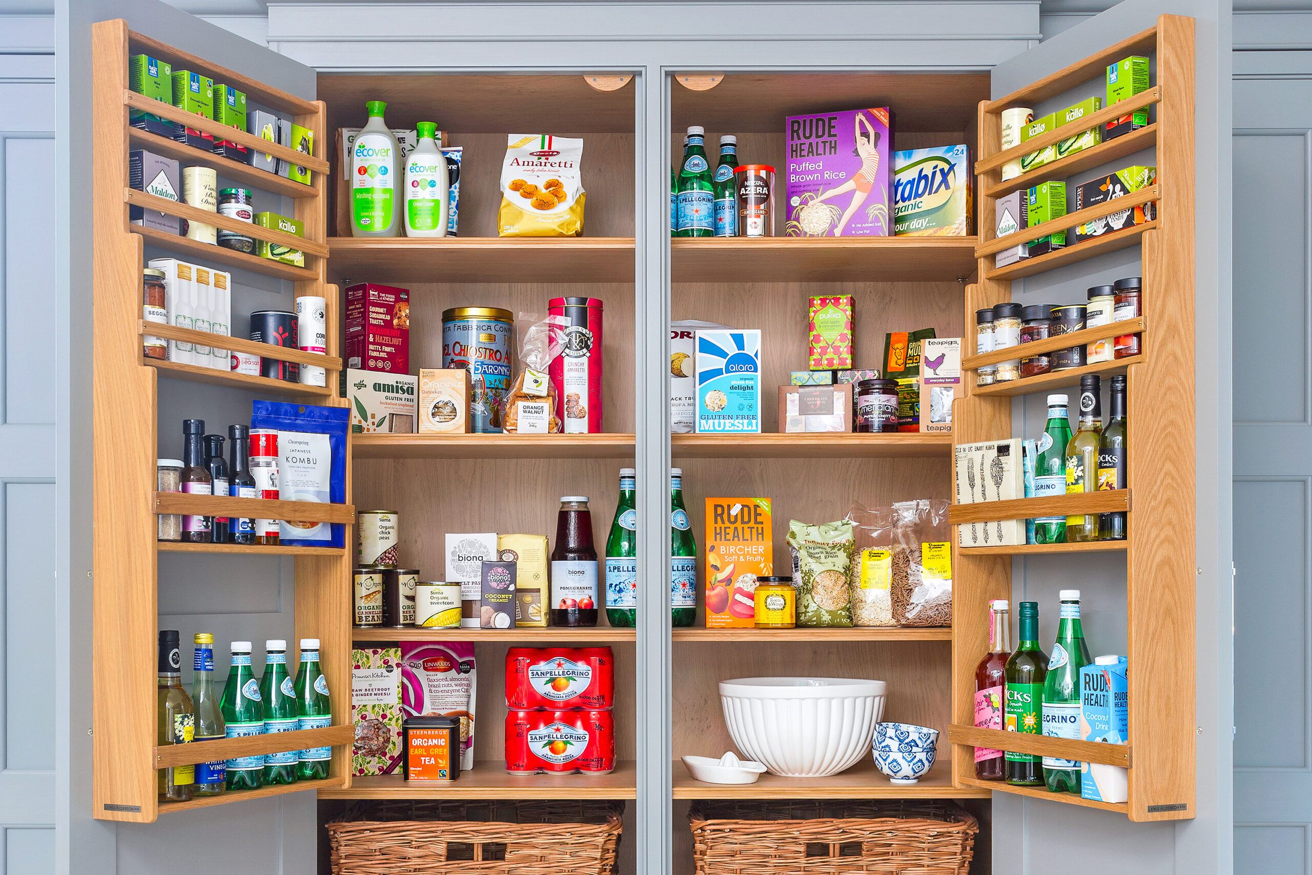 Well-organized kitchen pantry stocked with food, drinks, spices, and cleaning supplies, showcasing ideal storage for pest prevention.